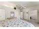 Spacious bedroom featuring a ceiling fan and direct access to the bath at 2373 Hounds Trl, Palm Harbor, FL 34683