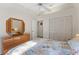 Bedroom with a large wooden dresser, a closet with folding doors, and a bed at 2373 Hounds Trl, Palm Harbor, FL 34683