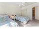 Bedroom featuring twin beds, a ceiling fan, closet with folding doors, and carpeted floors at 2373 Hounds Trl, Palm Harbor, FL 34683