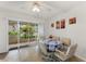 Sunlit dining area boasts a ceiling fan, backyard view and access to outdoor patio at 2373 Hounds Trl, Palm Harbor, FL 34683