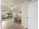 Cozy dining area with sliding doors offering serene views of lush greenery and natural light at 2373 Hounds Trl, Palm Harbor, FL 34683