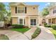 Inviting front exterior of townhome with well-maintained landscaping and a sidewalk at 2373 Hounds Trl, Palm Harbor, FL 34683
