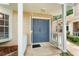 Inviting front entrance featuring a blue double door and covered porch at 2373 Hounds Trl, Palm Harbor, FL 34683