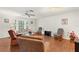 Comfortable living room with ample seating, ceiling fan, and bright natural light at 2373 Hounds Trl, Palm Harbor, FL 34683