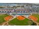 Aerial view of the community featuring baseball fields, tennis courts and a pool area at 250 Medallion Blvd # H, Madeira Beach, FL 33708