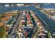 A high-angle view of coastal townhomes that highlights the community pool, canal access, and convenient parking at 250 Medallion Blvd # H, Madeira Beach, FL 33708