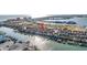 An aerial shot showcasing townhomes with private docks, situated alongside a scenic waterfront and recreational areas at 250 Medallion Blvd # H, Madeira Beach, FL 33708