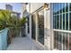 Balcony with patio furniture and views of tropical plants at 250 Medallion Blvd # H, Madeira Beach, FL 33708