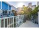 Balcony with patio furniture, blue railings, and lush tropical landscaping at 250 Medallion Blvd # H, Madeira Beach, FL 33708