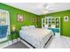 Bright green bedroom featuring a spacious bed, decorative shelves, and stylish décor at 250 Medallion Blvd # H, Madeira Beach, FL 33708