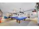 Bright community billiards room with pool tables, ceiling fans, and a lounge area at 250 Medallion Blvd # H, Madeira Beach, FL 33708