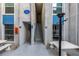 Inviting condo building entrance with unit numbers, open stairwell, and outdoor seating at 250 Medallion Blvd # H, Madeira Beach, FL 33708