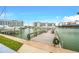 Community dock overlooking the waterway with boat slips and seating areas at 250 Medallion Blvd # H, Madeira Beach, FL 33708