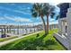 Condo community dock with palm trees and marina views, perfect for a relaxing stroll at 250 Medallion Blvd # H, Madeira Beach, FL 33708