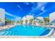 Resort-style community pool with lounge chairs on a sunny day at 250 Medallion Blvd # H, Madeira Beach, FL 33708