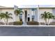 Inviting condo exterior with a well-maintained facade and lush landscaping at 250 Medallion Blvd # H, Madeira Beach, FL 33708
