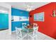Open dining area with vibrant colors and access to other rooms in the home at 250 Medallion Blvd # H, Madeira Beach, FL 33708