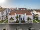 An attractive exterior shot of a two-story townhome with well-maintained landscaping and easy access to parking at 250 Medallion Blvd # H, Madeira Beach, FL 33708