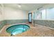 Indoor hot tub with tiled surround, providing a relaxing and luxurious amenity at 250 Medallion Blvd # H, Madeira Beach, FL 33708