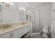 Bright bathroom with double sinks, marble countertops, and a glass-enclosed shower at 2523 W Sunset Dr, Tampa, FL 33629