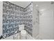 Chic bathroom with blue tiger wallpaper, white subway tile shower, and modern fixtures at 2523 W Sunset Dr, Tampa, FL 33629