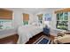 Cozy bedroom with natural light, hardwood floors, and a plush bed with throw pillows at 2523 W Sunset Dr, Tampa, FL 33629