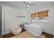 Comfortable bedroom featuring natural light, hardwood floors, and a white bed with accent pillows at 2523 W Sunset Dr, Tampa, FL 33629