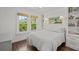 Charming bedroom featuring natural light, hardwood floors, and a neatly dressed bed at 2523 W Sunset Dr, Tampa, FL 33629