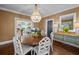 Charming dining room featuring elegant wallpaper, chandelier and modern table at 2523 W Sunset Dr, Tampa, FL 33629