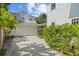 Exterior view of home with two-car garage and driveway lined with mature landscaping at 2523 W Sunset Dr, Tampa, FL 33629