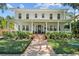 Inviting two-story home with a spacious front porch, manicured lawn, and brick pathway at 2523 W Sunset Dr, Tampa, FL 33629