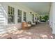 Relaxing front porch features wicker seating and a hanging swing for outdoor enjoyment at 2523 W Sunset Dr, Tampa, FL 33629