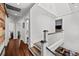 Hallway with hardwood floors leading to bedrooms and a view of the living area at 2523 W Sunset Dr, Tampa, FL 33629