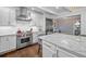 Bright kitchen featuring white cabinets, marble countertops, and a stainless steel Wolf range at 2523 W Sunset Dr, Tampa, FL 33629