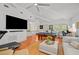 Bright and airy living room with a pool table, hardwood floors, and neutral decor at 2523 W Sunset Dr, Tampa, FL 33629