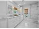 Luxurious bathroom with marble floors, a double vanity, and a large walk-in shower at 2523 W Sunset Dr, Tampa, FL 33629