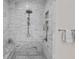 Luxurious marble walk-in shower featuring a rainfall showerhead and built-in shelving at 2523 W Sunset Dr, Tampa, FL 33629