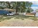 Spacious backyard featuring a truck under a carport and a storage shed at 2604 Oakdale St, Seffner, FL 33584