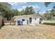 Backyard view of the rear of the house with back door, AC unit, and partial fence at 2604 Oakdale St, Seffner, FL 33584