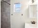A modern bathroom with stylish gray tiling, a sleek vanity, and a window for natural light at 2604 Oakdale St, Seffner, FL 33584