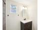 A modern bathroom featuring a stylish vanity, a window, and a shower with contemporary fixtures at 2604 Oakdale St, Seffner, FL 33584