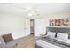 A staged bedroom with stylish decor, a comfortable chair, and ample natural light at 2604 Oakdale St, Seffner, FL 33584
