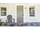 Close-up of the home's entrance, highlighting the stylish gray door and tiled porch at 2604 Oakdale St, Seffner, FL 33584