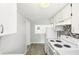 Efficient kitchen space with white appliances and a pass-through window to the living room at 2604 Oakdale St, Seffner, FL 33584