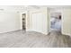 Open living room with wood-look tile flooring and a view to the kitchen and storage area at 2604 Oakdale St, Seffner, FL 33584