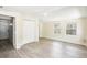Living room featuring wood-look tile flooring, white ceiling, and closet, with views of the entry door at 2604 Oakdale St, Seffner, FL 33584