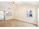 Bright and airy living room featuring light wood floors and a window overlooking the backyard at 2604 Oakdale St, Seffner, FL 33584