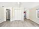 Living room featuring wood-look tile flooring, white ceiling, and closet, with views of the kitchen at 2604 Oakdale St, Seffner, FL 33584