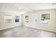 Bright living room with wood-look tile flooring, white ceiling and trim, and multiple windows at 2604 Oakdale St, Seffner, FL 33584