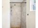 Modern shower with neutral tiling, including shower head, and a window for natural light at 2604 Oakdale St, Seffner, FL 33584